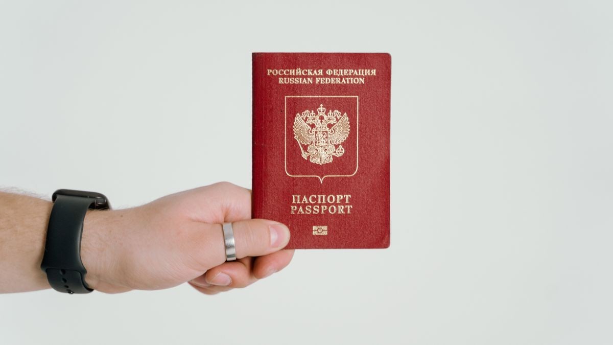 Close-up of a hand holding a Russian Federation passport.